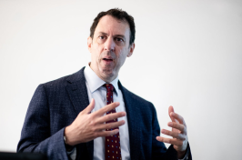 UNH Associate Professor Stephen Ciccone leads a lecture at the front of the classroom. 